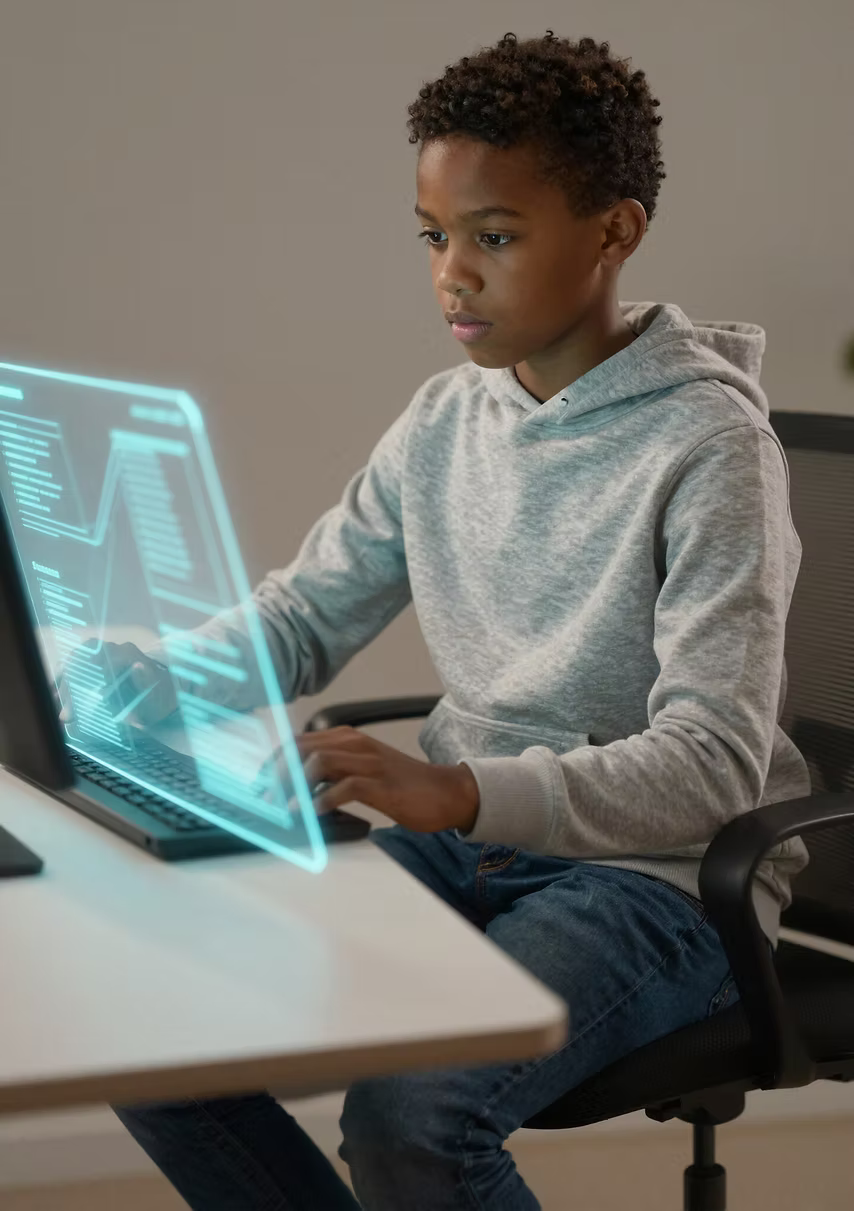 A child working intently at a laptop with a glowing holographic interface showing an invention plan
